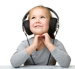 Image showing Cute girl enjoying music using headphones