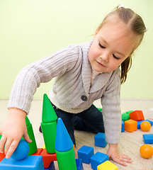 Image showing Little girl is playing with toys in preschool