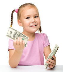 Image showing Cute little girl with paper money - dollars