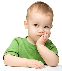 Image showing Pensive little boy support his head with hand