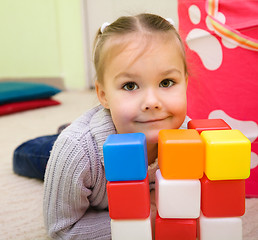 Image showing Little girl is playing with toys in preschool