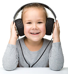 Image showing Cute girl enjoying music using headphones