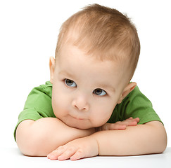 Image showing Pensive little boy support his head with hands