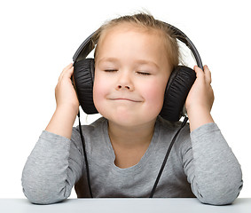 Image showing Cute girl enjoying music using headphones