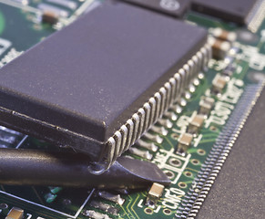 Image showing taking chip from circuit board by force