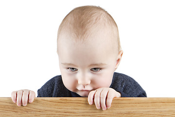 Image showing young child holding wooden board