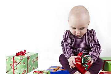 Image showing young child unpacking presents