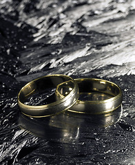 Image showing two golden wedding rings on ice surface