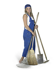 Image showing cute girl dressed in workwear with lots of gardening tools