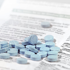 Image showing blue pills on package insert