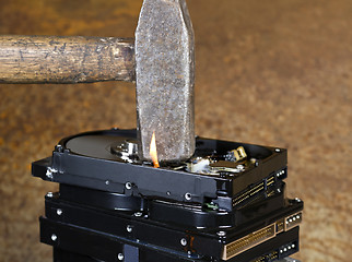 Image showing hammer and burning hard disks