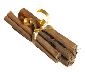 Image showing cinnamon sticks with golden bow