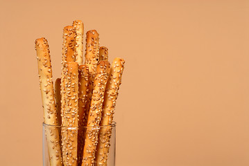 Image showing Sesame breadsticks in clear glass