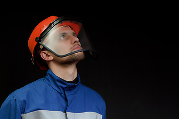 Image showing The worker in overalls and a helmet