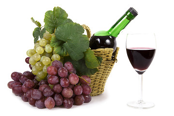 Image showing white and red grape with leaves and bottle of wine in the basket