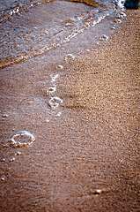 Image showing Bubbles and sand on the shore of the beach