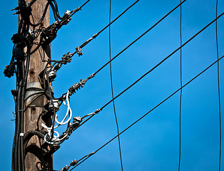 Image showing High voltage post against blue sky