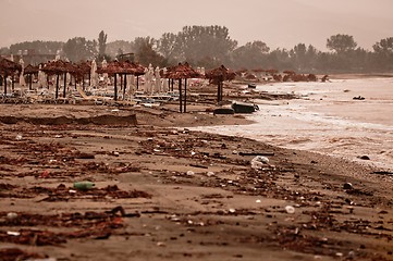 Image showing A dirty polluted beach  in the rain