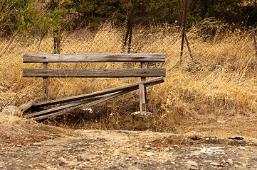 Image showing A damaged bench in the park