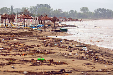 Image showing A dirty polluted beach  in the rain