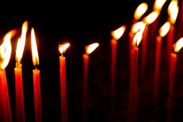 Image showing Red candles in a row glowing