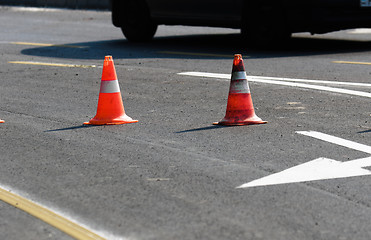 Image showing Road block with white arrow showing the alternate way