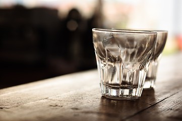 Image showing Empty glasses on wooden bar