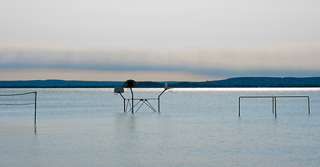 Image showing Tranquil scene of a shore with some shilhouettes