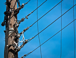 Image showing High voltage post against blue sky