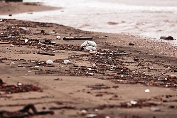 Image showing A dirty polluted beach  in the rain