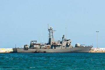 Image showing Big battle ship in the dock against blue sky and mountains
