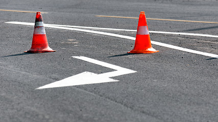 Image showing Road block with white arrow showing the alternate way