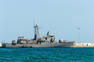 Image showing Big battle ship in the dock against blue sky and mountains