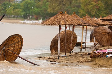 Image showing A dirty polluted beach  in the rain