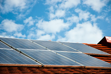 Image showing Cells of solar energy panels on the roof of a building