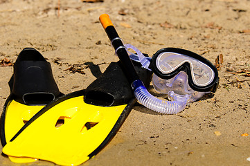 Image showing Goggles and flippers on the shore