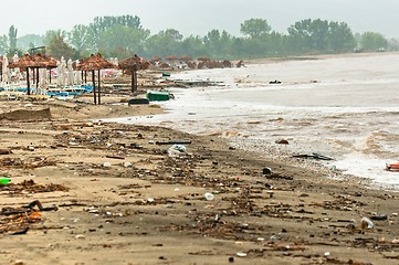 Image showing A dirty polluted beach  in the rain