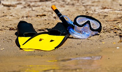 Image showing Goggles and flippers on the shore