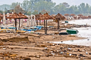 Image showing A dirty polluted beach  in the rain