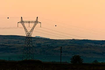 Image showing Hihg voltage post against sky at dusk