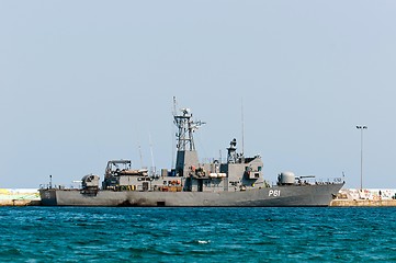 Image showing Big battle ship in the dock against blue sky and mountains