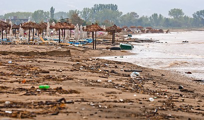 Image showing A dirty polluted beach  in the rain