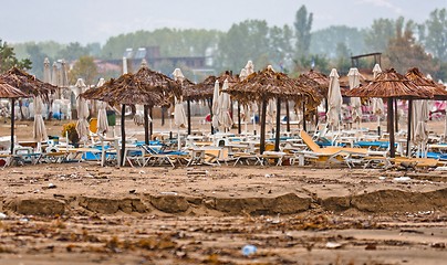 Image showing A dirty polluted beach  in the rain