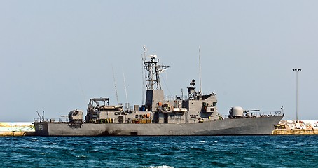 Image showing Big battle ship in the dock against blue sky and mountains