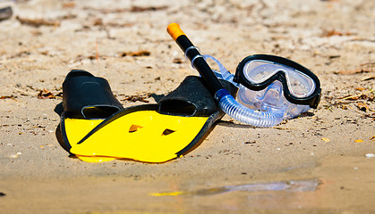 Image showing Goggles and flippers on the shore