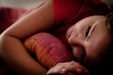 Image showing Young beautiful girl lying in bed