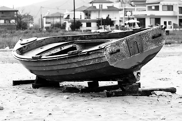 Image showing Abandoned fishing boat on the shore in balck and white