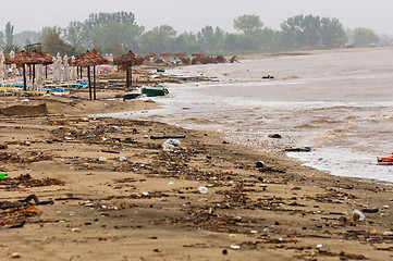 Image showing A dirty polluted beach  in the rain