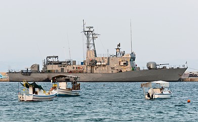 Image showing Big battle ship in the dock against blue sky and mountains