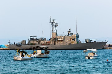 Image showing Big battle ship in the dock against blue sky and mountains